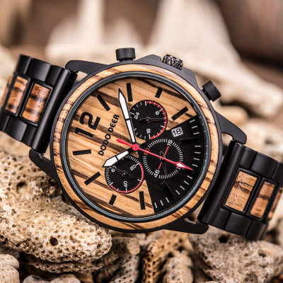 Wooden watch with black and red details on a textured surface