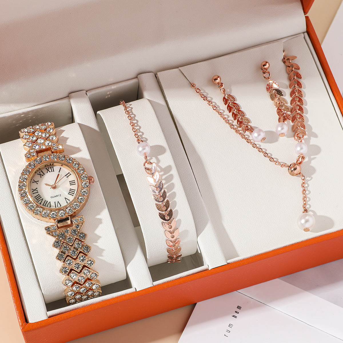 Rose gold watch and bracelet set in an open box