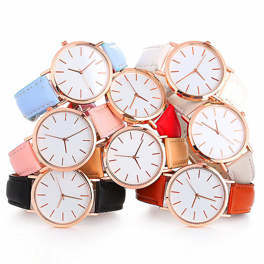 Multiple watches with different colored straps on a white background