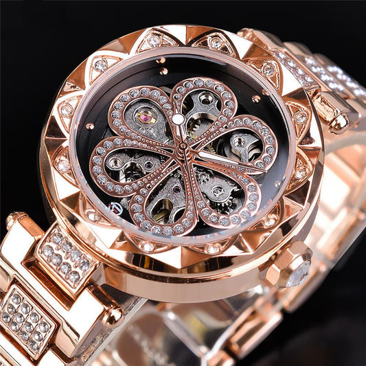 Luxury rose gold watch with intricate design and diamond accents on a black background