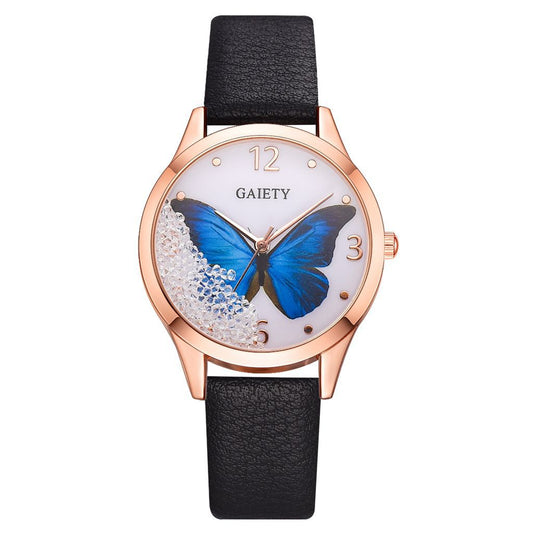 Wristwatch with blue butterfly design on the dial, black strap, and rose gold casing.