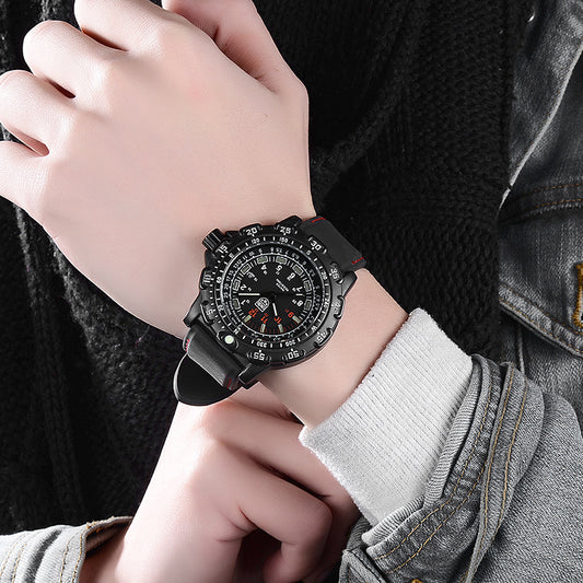 Person wearing a black wristwatch with a detailed face, sitting on a dark background.