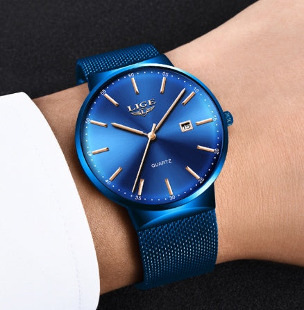 Blue wristwatch with 'LIGE' branding on a person's wrist against a black background